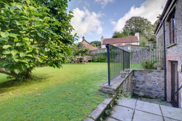 Steps lead up to a quiet lawned courtyard garden