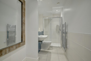 The spacious family bathroom with large walk in shower 