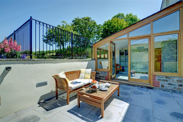 Front patio area with outside sofa and coffee table