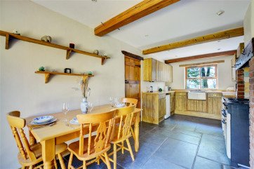 Traditional cottage kitchen with table & chairs.