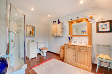 The ensuite shower room benefits from a walk in shower, wc and basin