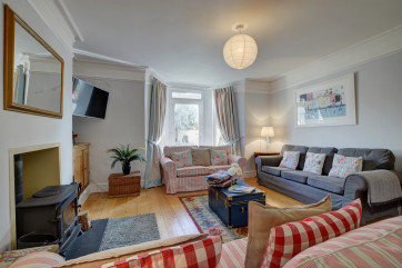 The sitting room has plenty of sofas and a woodburner, great for cooler evenings