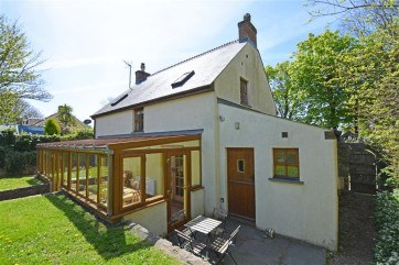 An exterior view of the sun room and garden