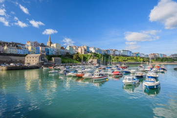 A photo of Tenby Harbour with boats bobbing up and down