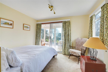 Master double bedroom with ensuite bathroom leading to convervatory and sea views