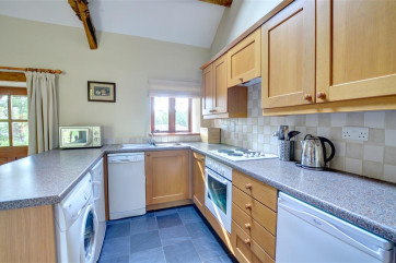 There is a smart fitted kitchen area to one end of the spacious open plan living accommodation