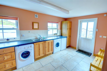 Large utility room offers some extra storage. Also there is a freezer, a washing machine and tumble dryer.