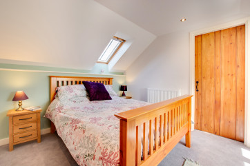 The double bedroom has plenty of storage and is decorated with thoughtful calming touches