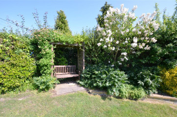 Enjoy a lazy afternoon in this arbour with a view of the garden.