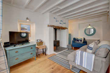 The cosy sitting room has very comfortable sofas and seaside decor