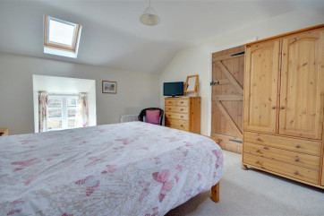 King size bed with wardrobe and chest of draws and Freeview TV.