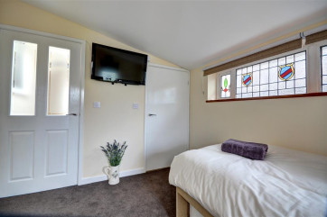 Bedroom 3 has a single bed, TV and En suite