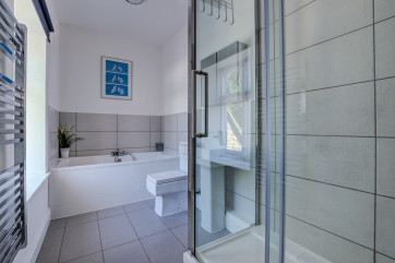 The bathroom is sprakling brand new and is furnished with a modern white bathroom suite comprising of a panelled bath and a large separate shower cubicle, low level WC and pedestal washbasin.
