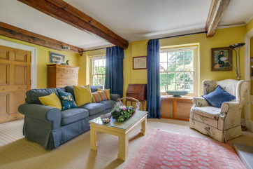 Colourful sitting room with comfortable seating and character features