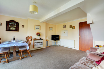 Comfy sofas in a spacious sitting room with a gas fire for cosy evenings