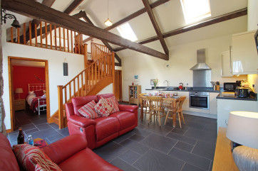 Open plan living area - spacious double height room with beams