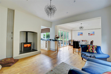 The open plan living room has a gas living flame fire