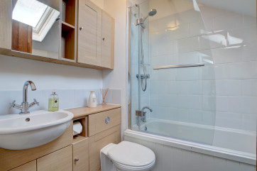 The modern family bathroom with shower over bath