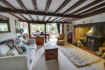 Comfortable, beamed sitting room with feature fireplace