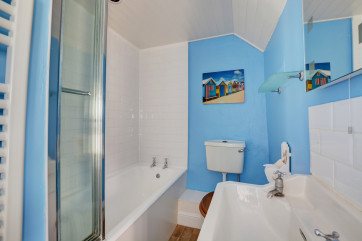 Bright colourful bathroom with bath and over-bath shower