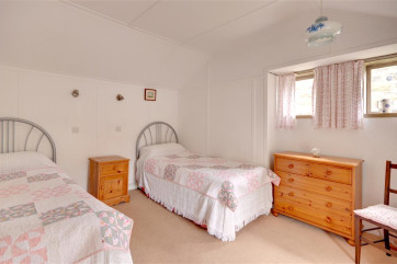 Bedroom 3 has two single beds.
