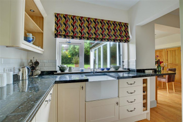 The kitchen has an electric double oven and gas hob