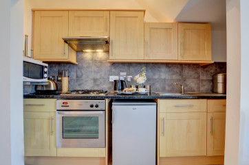 The compact kitchen is well equipped for your stay