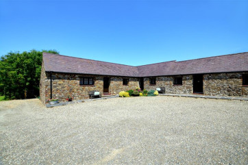 Exterior shot of all the cottages, converted from stone farm buildings