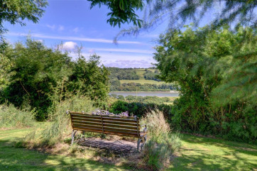 The peacefully located cottage stands in well-maintained grounds overlooking the River Tywi