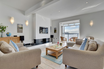 The spacious open plan living room is on the first floor to take advantage of the wonderful views