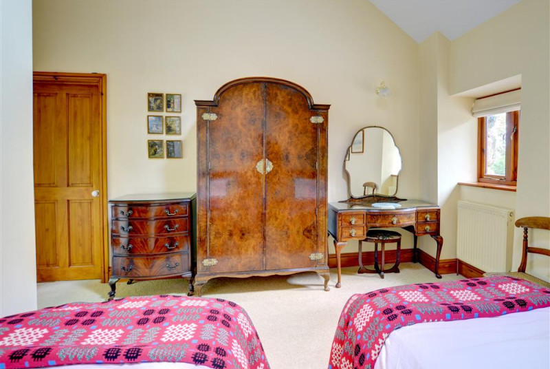 The twin bedroom also has impressive antique bedroom furniture