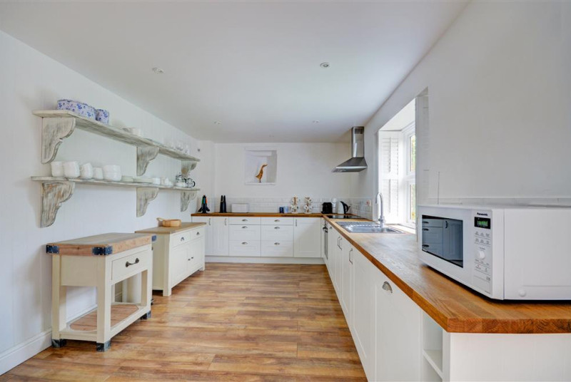 The kitchen is a spacious area with electric hob and oven