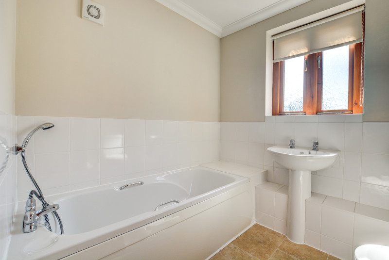 Bathroom with bath and shower over, washbasin and w.c