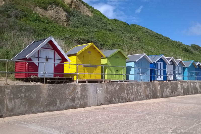 Brightly coloured beach huts at Overstrand