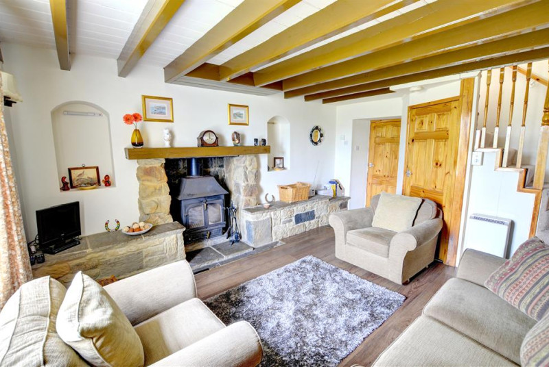 The cosy Lounge features a wood-burning stove.