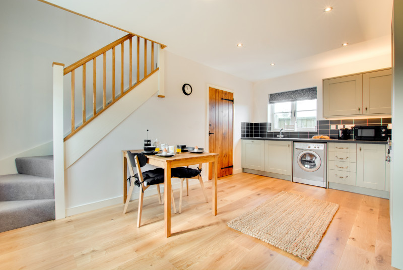 Bright and modern, the kitchen is well equipped with stairs to the first floor