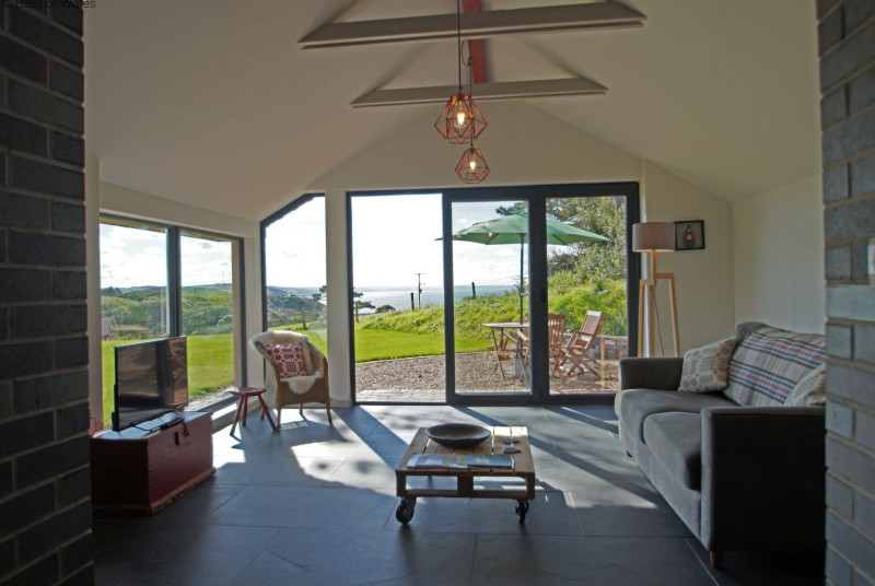 Spacious and light lounge with far reaching views over Cardigan Bay