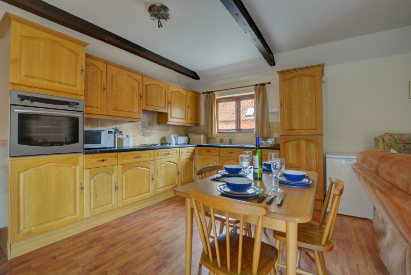 Large, modern kitchen with a dining table and chairs, perfect for family meals