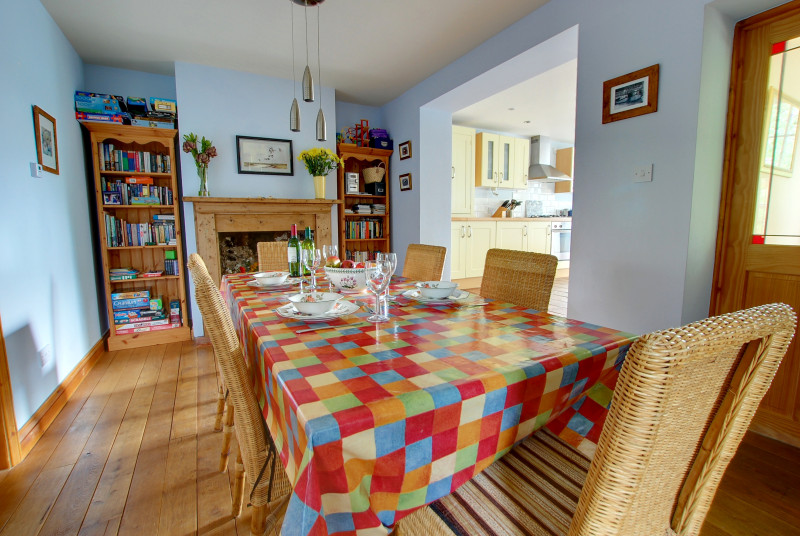 Spacious dining room with a long table and six chairs, a lovely area for family meals