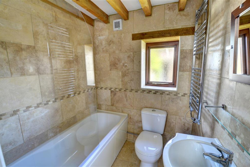Smart contemporary bathroom with shower over bath