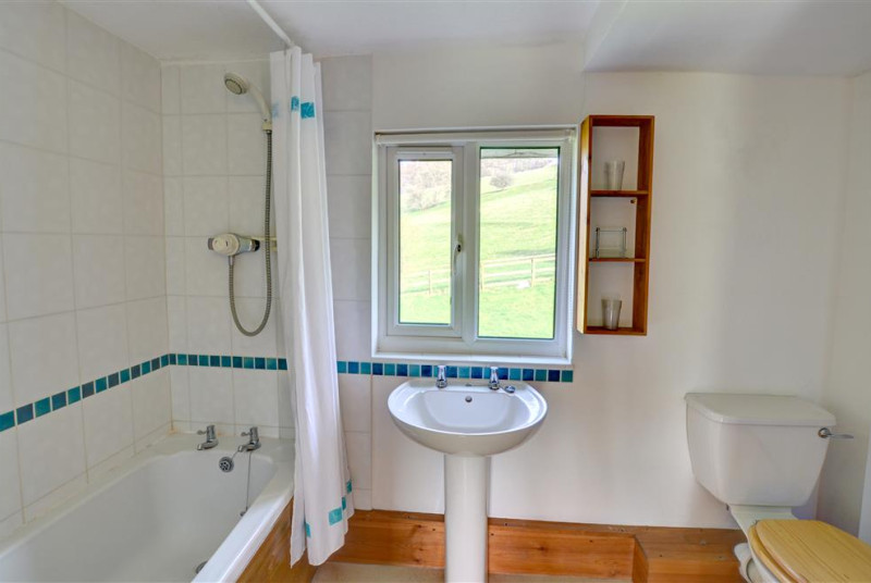 The second smaller bathroom also has a shower over the bath, and lovely views over open fields!