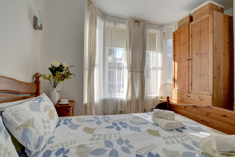 Light and bright double bedroom attractively furnished with large bay windows