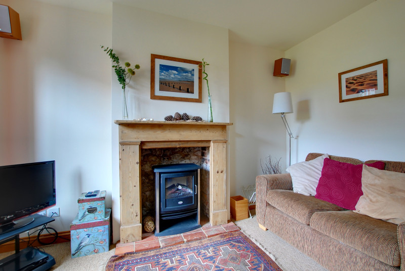 The sitting room has an attractive fire place with an electric living flame fire that supplements the gas central heating and gives a cosy feel