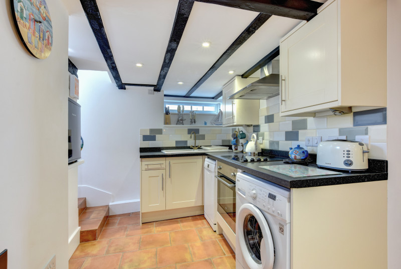 Kitchen: Stylish and well equipped with gas hob, electric oven, microwave, fridge/freezer, dishwasher and washing machine. Door out onto the rear courtyard garden with BBQ.