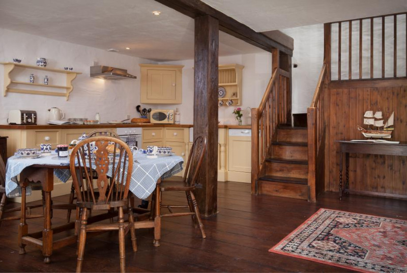 country cottage with exposed beams and open-plan kitchen dining room