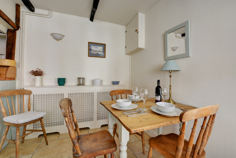Table and chairs with window looking out to the front of the property.