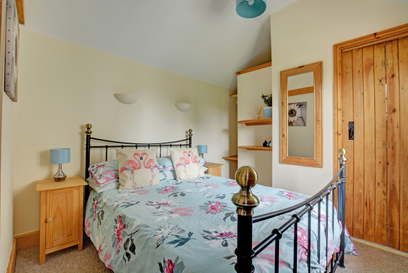 Pretty double bedroom with wrought iron double bed and en-suite shower room
