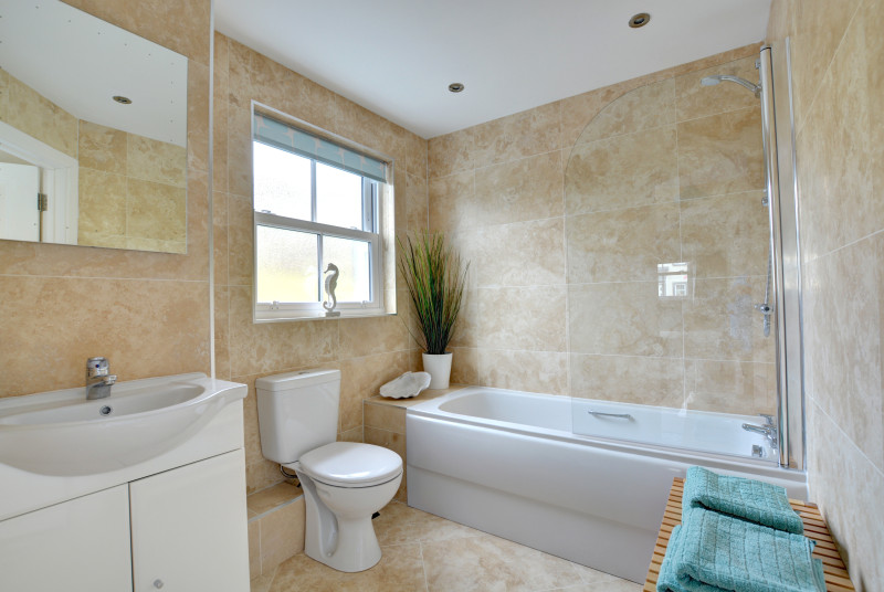 Bath with shower over, toilet and wash basin