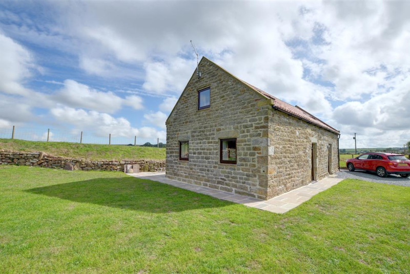 The cottage is detached surrounded by open countryside.