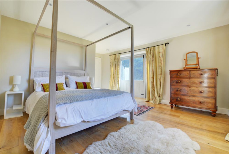 Main bedroom with king sized four poster bed
